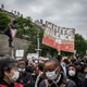 People take part in a rally on June 9, 2020, in Geneva, during a demonstration against racism and police brutality in the wake of the death of George Floyd, an unarmed black man killed while apprehended by police in Minneapolis.